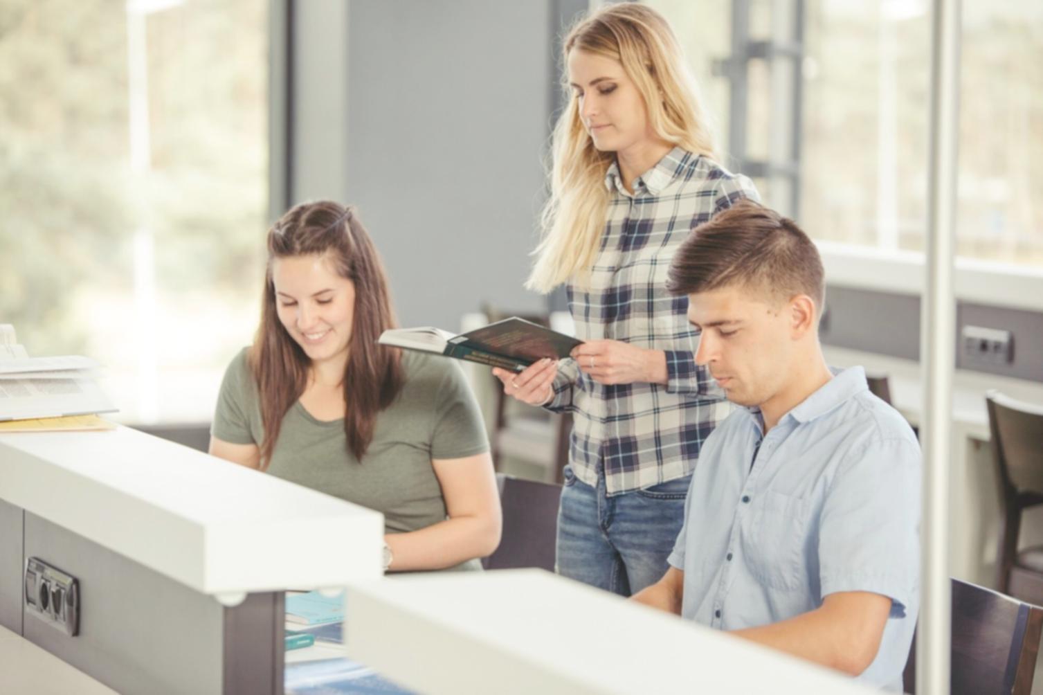 Financial reports and budget analysis documents spread on desk with calculator